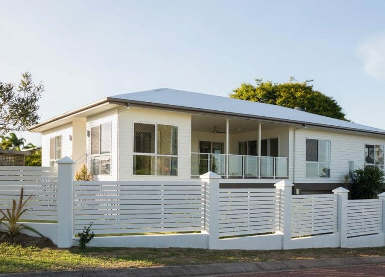 Clôture blanche sur mesure devant une maison