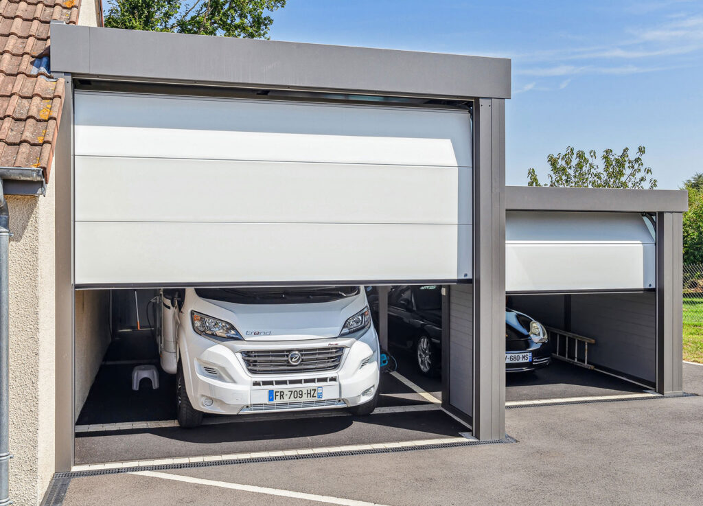Porte de garage enroulable motorisée ouverte sur un camping-car